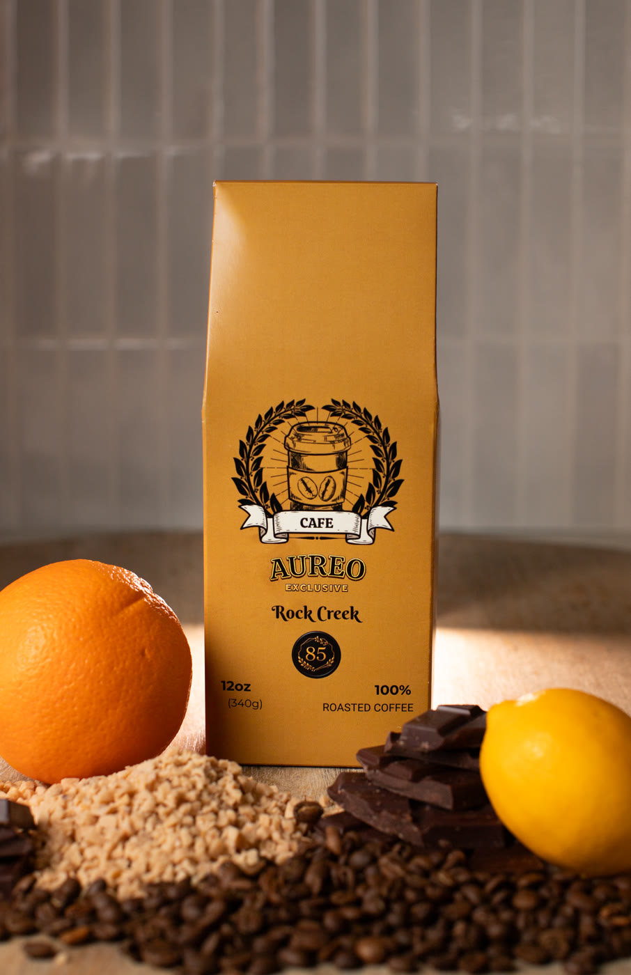 Aureo Café coffee bag styled with an orange, chocolate and coffee beans